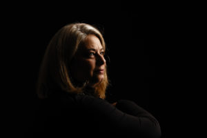Woman's portrait on black with dramatic lighting