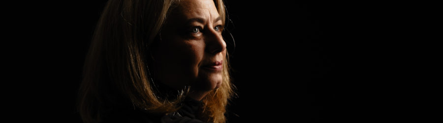 Woman's portrait on black with dramatic lighting